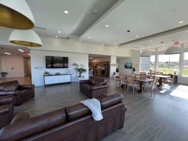 A common area with a tv, couches and dinning area.