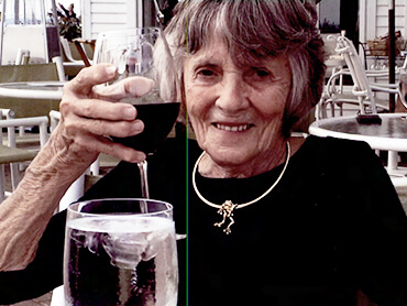 Jane gives a toast with a glass of red wine.