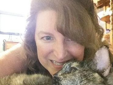 Close up of Christina snuggling her pet.
