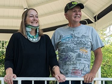 Jamie and her husband standing outside under a gazebo.